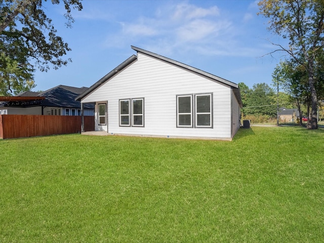 rear view of house with a yard