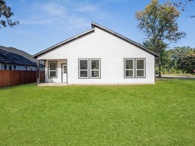 rear view of house with a yard