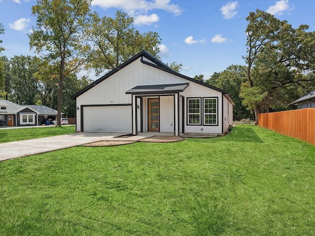 view of front of property with a garage and a front yard