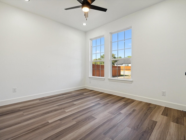 empty room with hardwood / wood-style flooring and ceiling fan