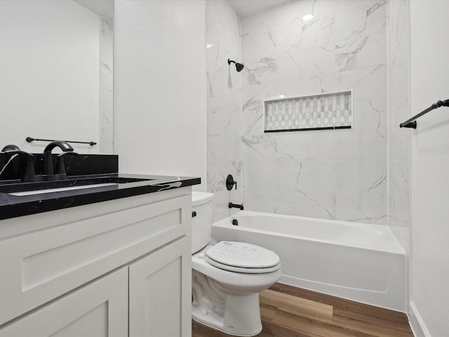 full bathroom featuring vanity, wood-type flooring, toilet, and washtub / shower combination