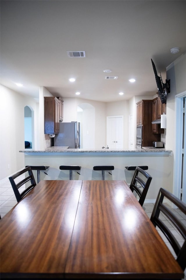 unfurnished dining area featuring light tile patterned floors