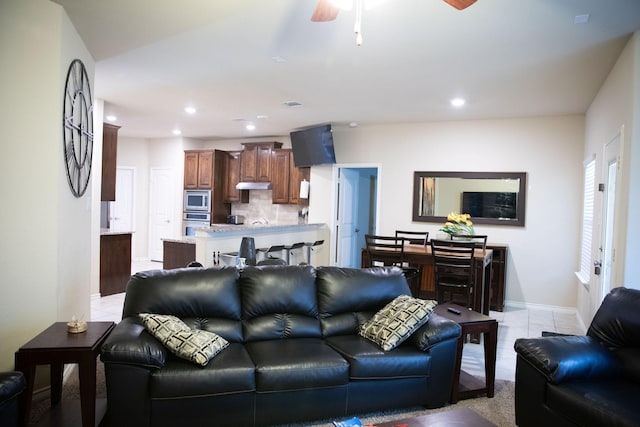 living room featuring light tile patterned floors and ceiling fan