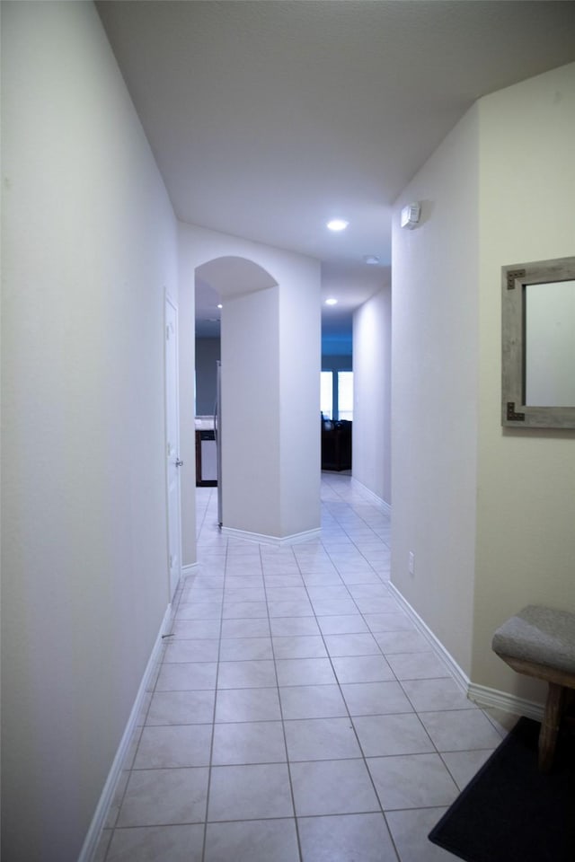 hall with light tile patterned floors