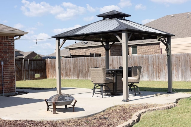 view of patio featuring a gazebo and a fire pit