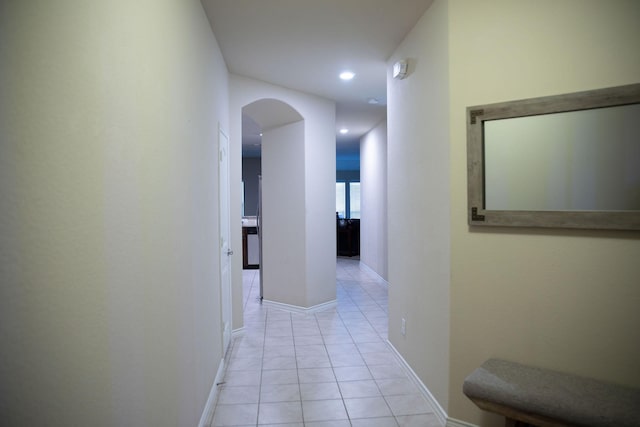 hall featuring light tile patterned flooring