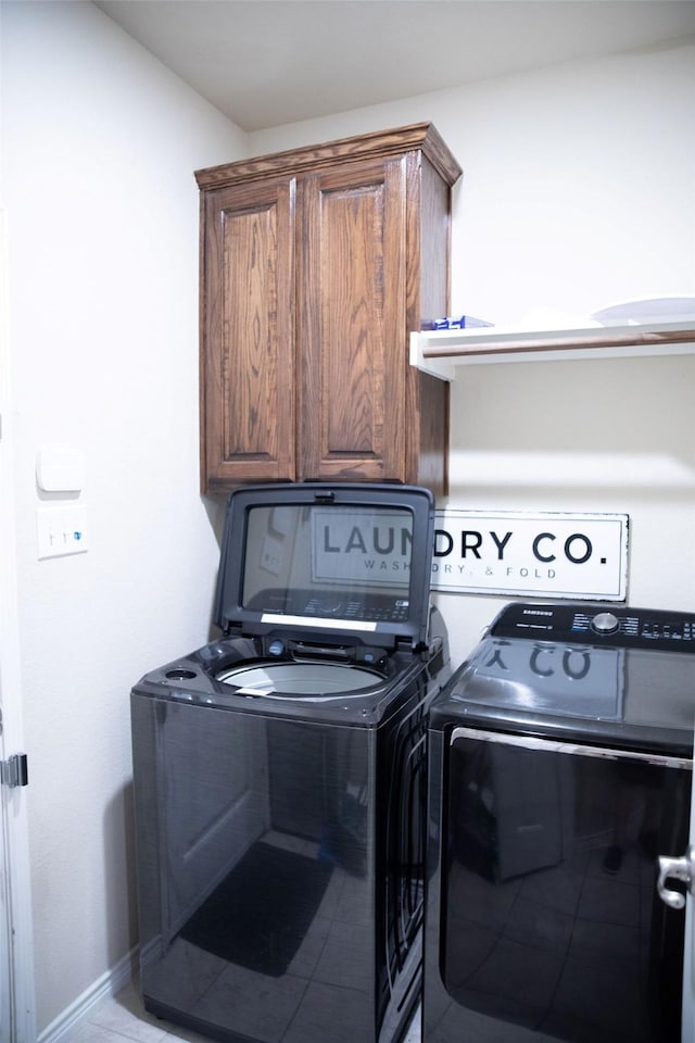 laundry room with cabinets and washer and dryer