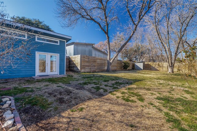 back of property featuring french doors and a yard