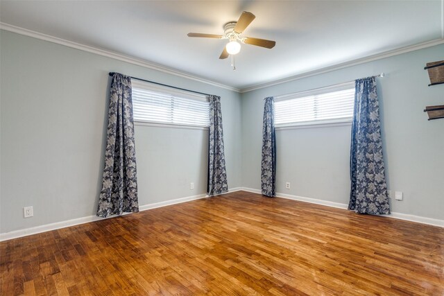 spare room with ceiling fan, crown molding, baseboards, and wood finished floors