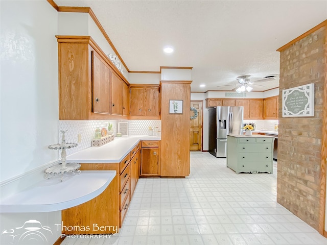 kitchen featuring decorative backsplash, stainless steel fridge, ornamental molding, and ceiling fan