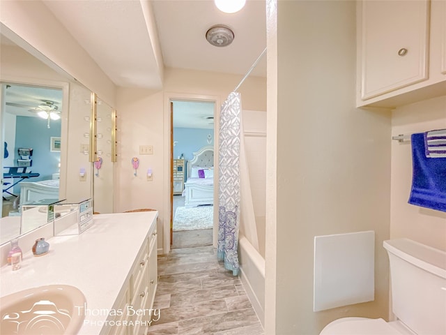 full bathroom with shower / bathtub combination with curtain, vanity, and toilet