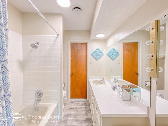 full bathroom with vanity, shower / bath combination with curtain, a textured ceiling, and toilet