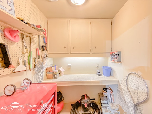 laundry room featuring cabinets