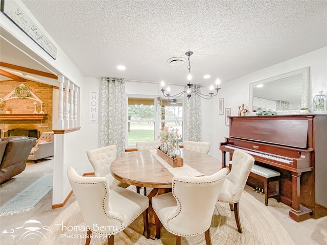 dining area featuring a notable chandelier, light carpet, and a textured ceiling