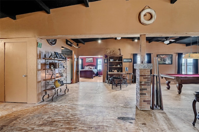 interior space featuring ceiling fan, pool table, and beam ceiling