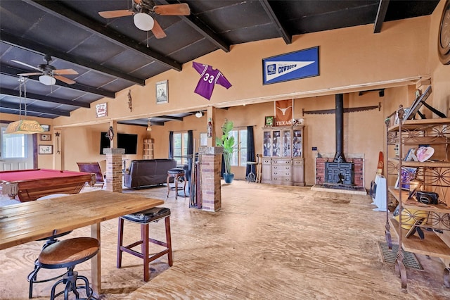 recreation room featuring vaulted ceiling with beams, billiards, ceiling fan, and a wood stove