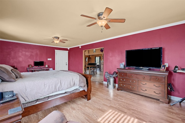 bedroom featuring ornamental molding, ceiling fan, and light wood-type flooring