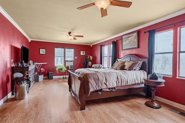 bedroom featuring ornamental molding, light hardwood / wood-style floors, and ceiling fan