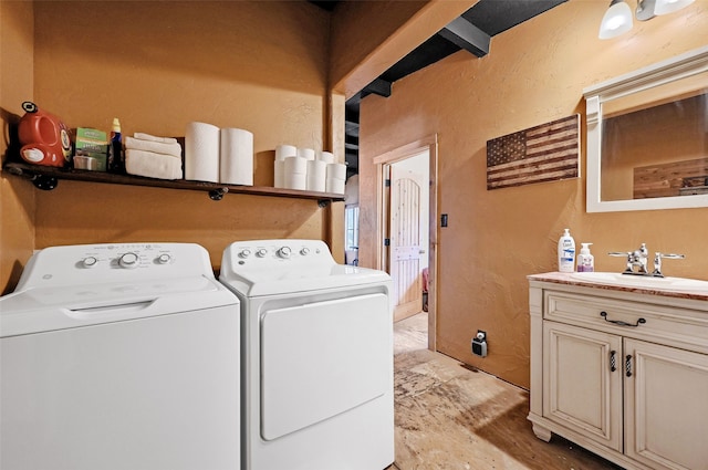 laundry room featuring cabinets, sink, and washing machine and dryer