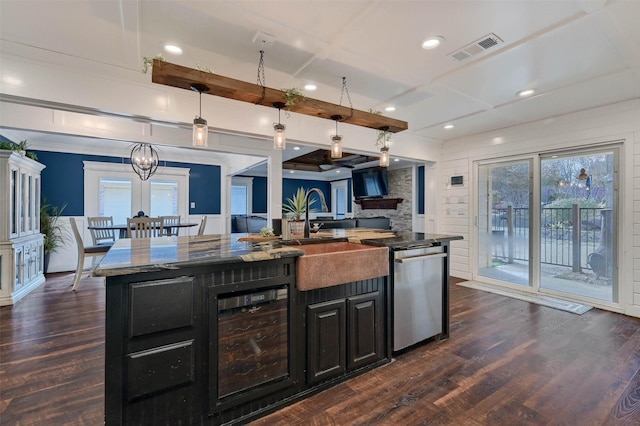 kitchen with wine cooler, sink, decorative light fixtures, a center island with sink, and dishwasher