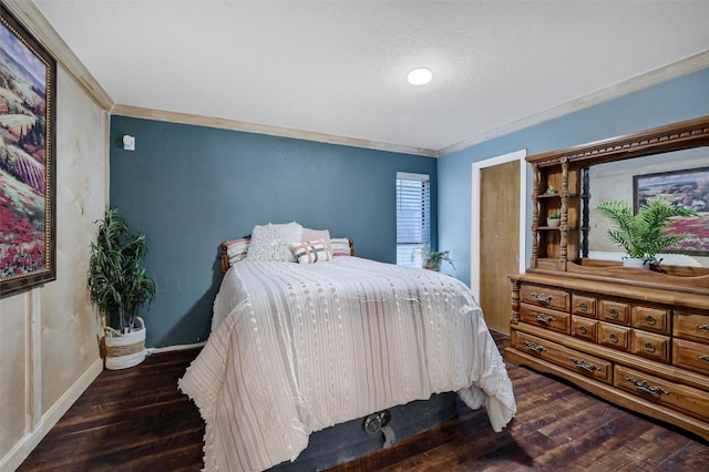 bedroom featuring ornamental molding, dark hardwood / wood-style floors, and a textured ceiling