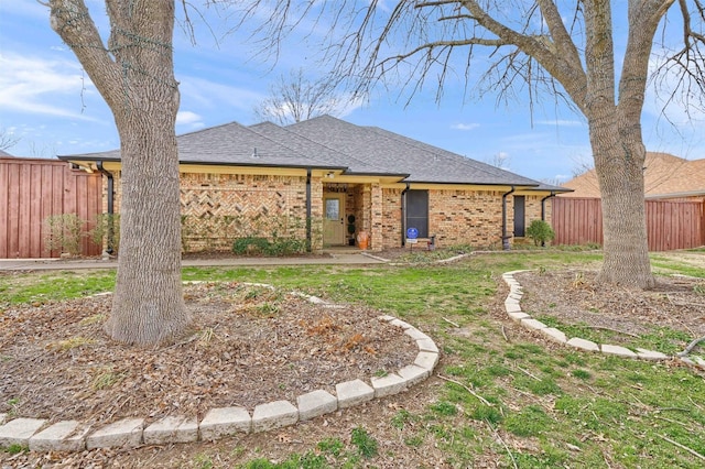 ranch-style house with a front lawn