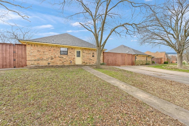 exterior space with a carport and a yard