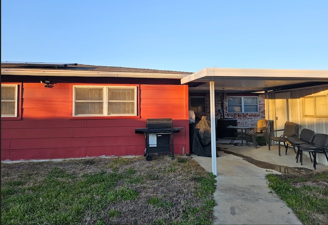 view of side of property featuring a patio area and solar panels
