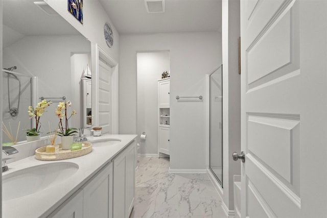 2313 Atlantic Ave, Anna, TX 75409 - bathroom with marble look tiles, a shower stall, double vanity, and baseboards