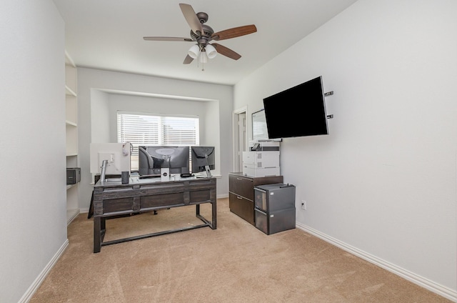 office area featuring light carpet and ceiling fan