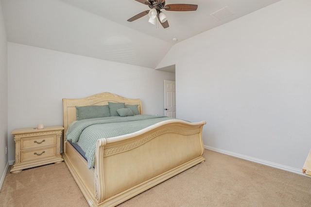 bedroom featuring ceiling fan, vaulted ceiling, and light carpet