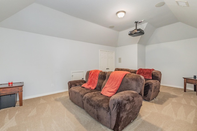 carpeted home theater with vaulted ceiling