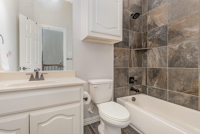 full bathroom with tiled shower / bath, vanity, and toilet