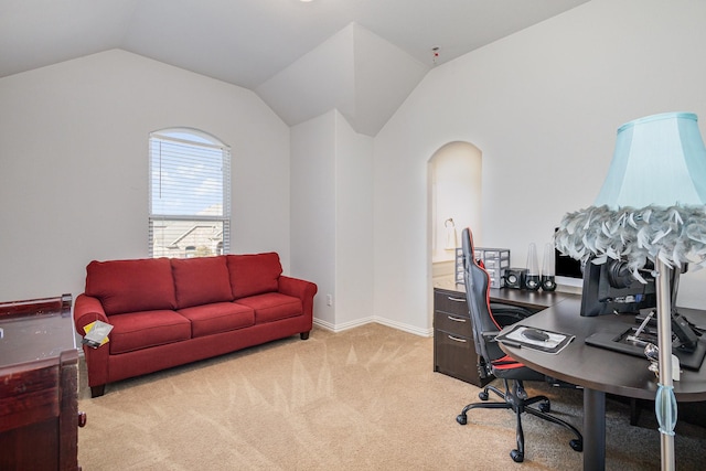 carpeted office featuring vaulted ceiling