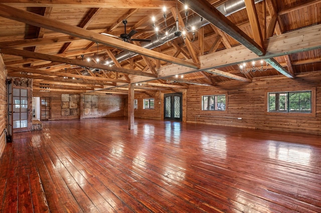 empty room featuring ceiling fan, hardwood / wood-style floors, high vaulted ceiling, wooden ceiling, and beamed ceiling