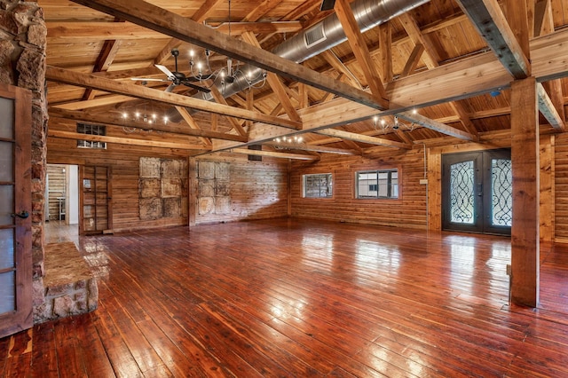 unfurnished living room with ceiling fan, beam ceiling, high vaulted ceiling, wooden ceiling, and french doors