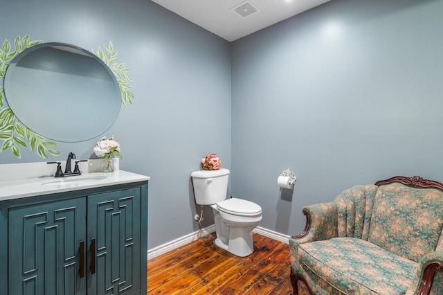 bathroom with vanity, hardwood / wood-style floors, and toilet