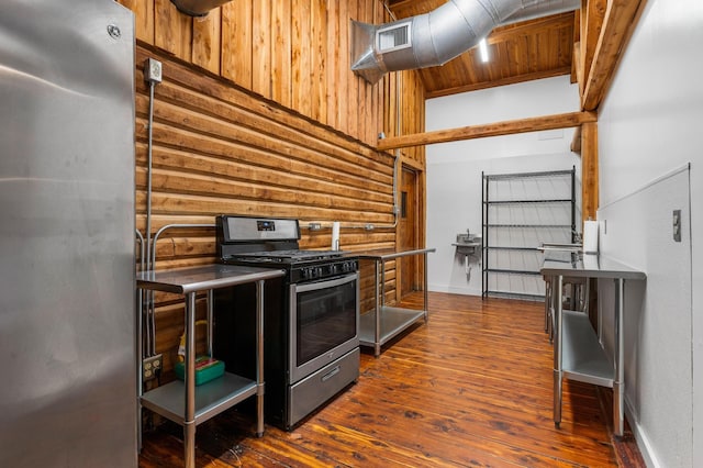 kitchen featuring wood walls, wood ceiling, dark hardwood / wood-style flooring, stainless steel appliances, and log walls