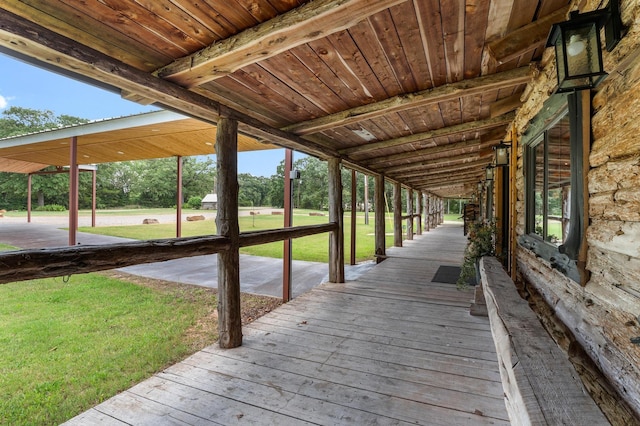 wooden terrace featuring a yard