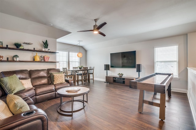 living room featuring vaulted ceiling, plenty of natural light, ceiling fan, and dark hardwood / wood-style flooring