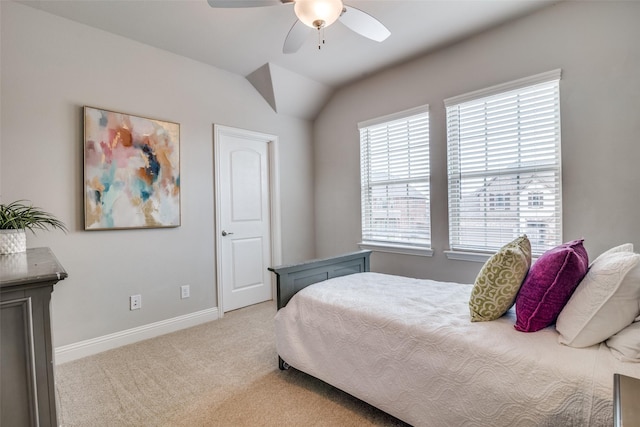 bedroom featuring vaulted ceiling, light colored carpet, and ceiling fan