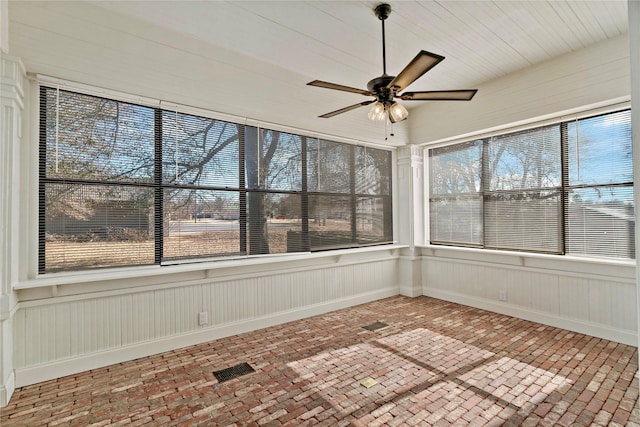 unfurnished sunroom with ceiling fan