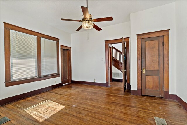 kitchen with dark wood-type flooring, white cabinets, and a textured ceiling