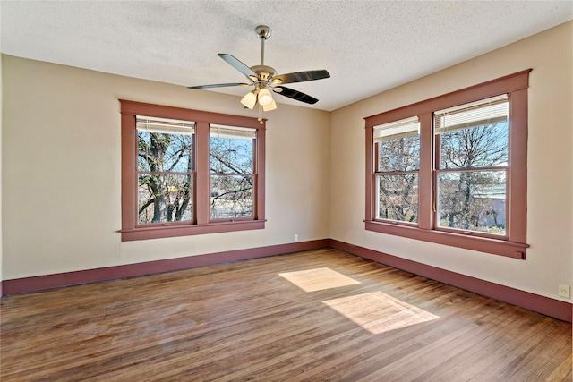 empty room with wood-type flooring, a textured ceiling, and ceiling fan