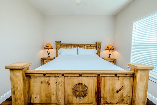 bedroom with dark hardwood / wood-style floors