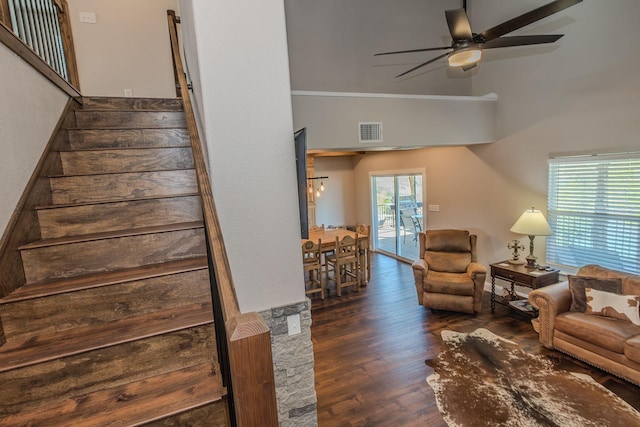 living room featuring plenty of natural light, ornamental molding, dark hardwood / wood-style floors, and ceiling fan