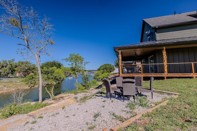 view of yard featuring a water view and a patio area