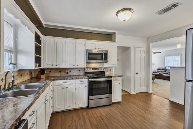 kitchen featuring white cabinetry, sink, wood-type flooring, and stainless steel appliances