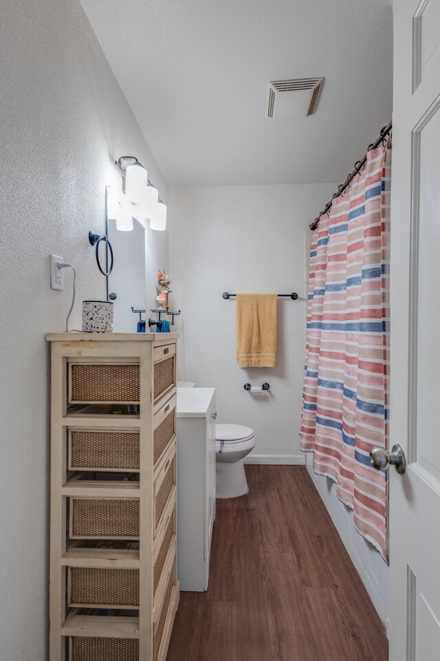 bathroom with vanity, hardwood / wood-style flooring, a textured ceiling, and a shower with shower curtain