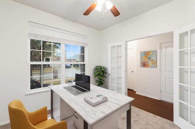 office area featuring baseboards, french doors, a ceiling fan, and wood finished floors